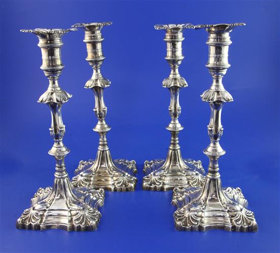 A set of four early George III cast silver candlesticks by William Cafe, 77 oz.